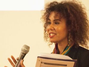 A Feminist Women’s Health Center staffer holds a microphone at a speaking event.