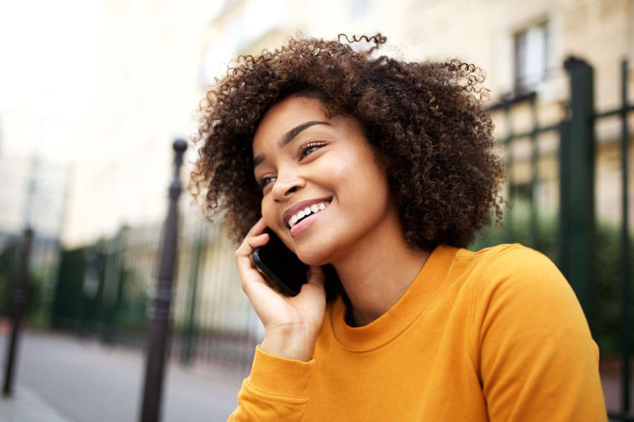 Model talking on the phone to make appointment with feminist women's health clinic.