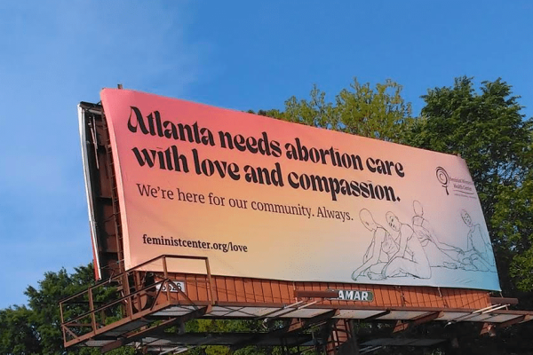 Photo of billboard with an ad that reads "Atlanta needs abortion care with love and compassion"