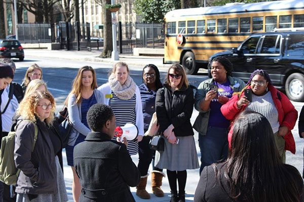 Person with bullhorn speaks to people organizing on a street in Atlanta, Georgia.